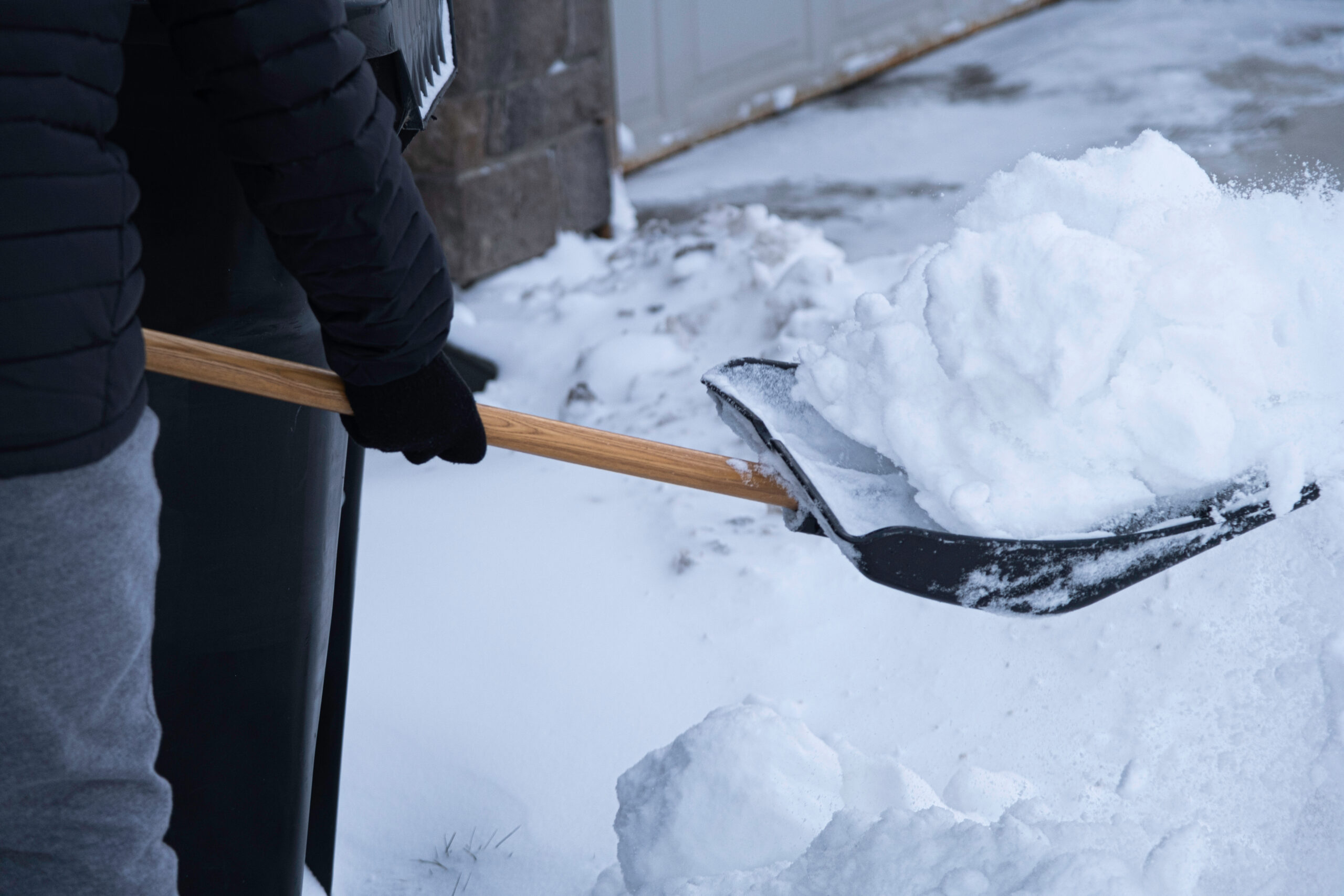 Clearing snow from driveway after heavy winter storm in Calgary